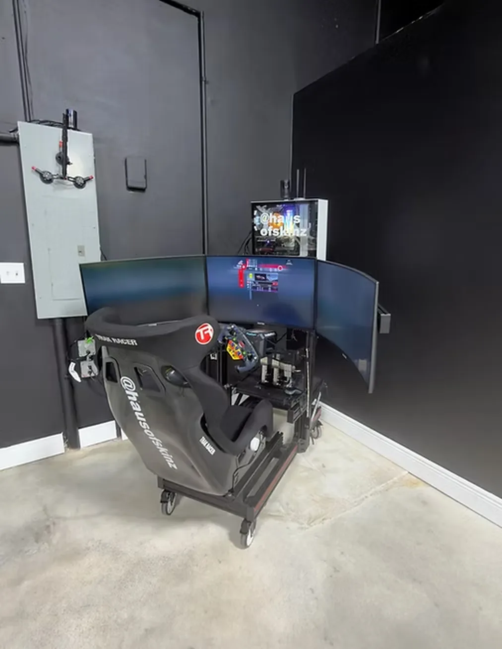A racing simulator rig set up on the shop floor