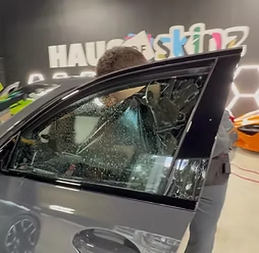 Window film being laid onto a side window